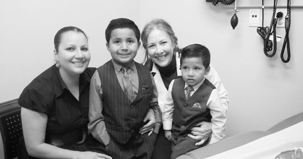 Marsha Griffin, MD with her patients, a mother and two children
