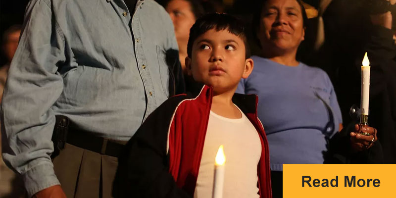 child holding candle looking nervous