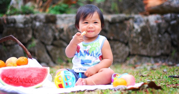 child eating food at a picnic