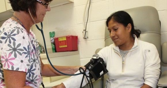 Nurse checks blood pressure of patient