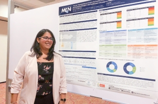 Marysel PagÃ¡n Santana poses with the poster she presented at the conference