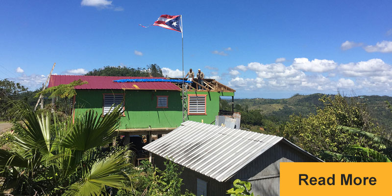 people standing on partial roof in Puerto Rico