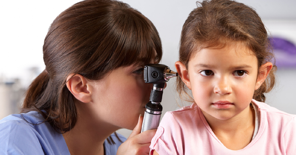 Clinician checks child's ear