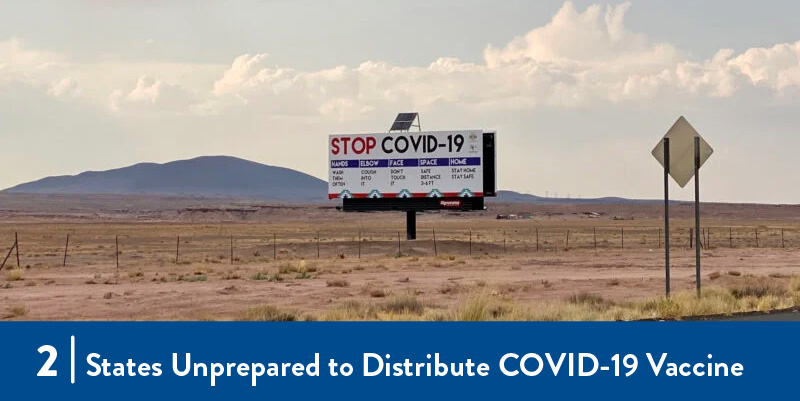 a billboard about COVID-19 in a field
