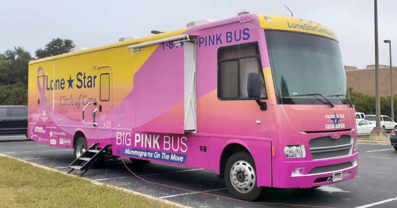 A pink bus used for medical exams