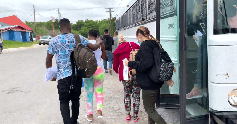 Asylum seekers getting off a bus