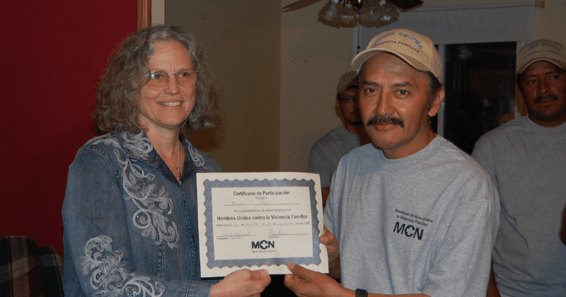 Candace handing certificate to class participant