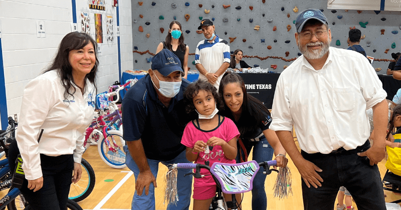 A photo with the winner of a bike at the health fair