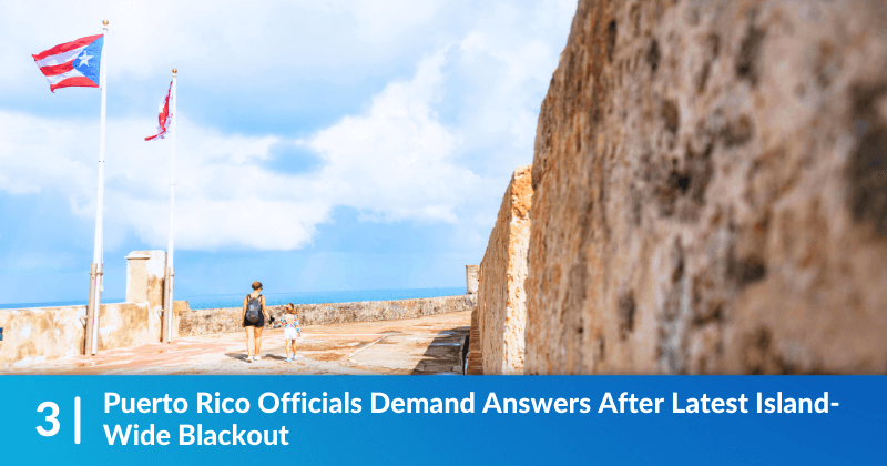 A mother and child walking underneath the Puerto Rican flag. Heading reads, "Puerto Rico Officials Demand Answers After Latest Island-Wide Blackout".