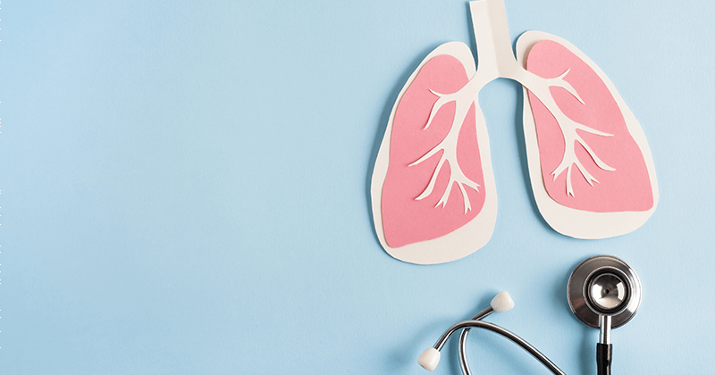 An image of paper lungs next to a stethoscope