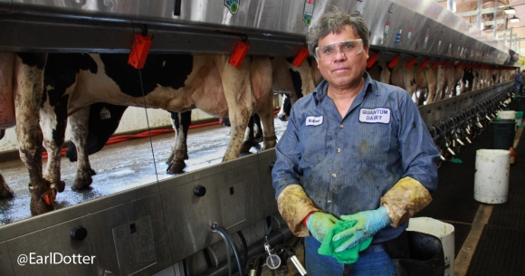 Man stands in front of dairy production
