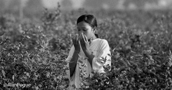 Farmworker girl coughs into hands