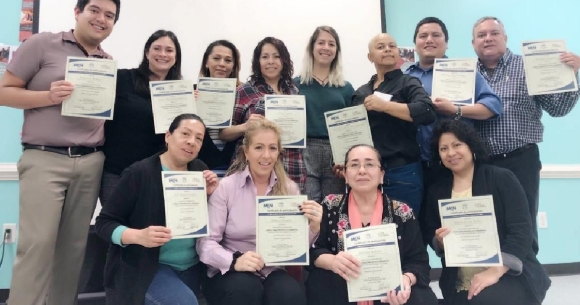 Training attendees pose with certificates