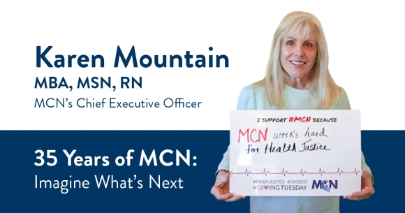 MCN CEO Karen Mountain holding an unselfie sign for giving tuesday