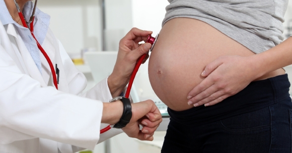 Doctor checks on health of pregnant mother and fetus