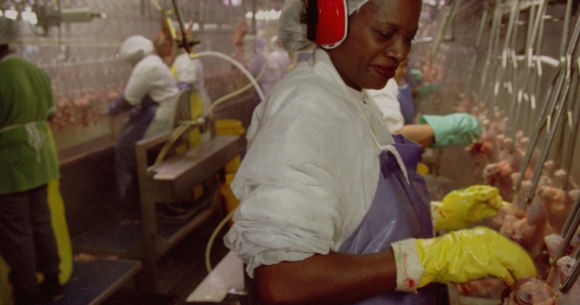 A worker on a processing line at a poultry plant
