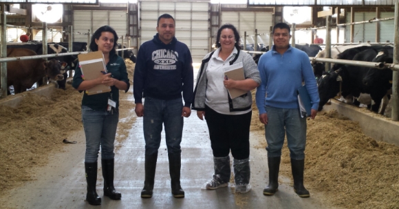 A photo of Patricia with two dairy workers