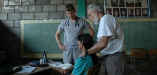 Ed Zuroweste and a medical student examine a patient