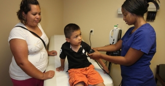 clinician taking child's blood pressure
