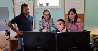 Nelly Salgado works with Robert Corona, Nestor Reyes, and Roxana Pineda