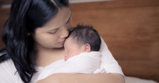 A woman holding her infant child