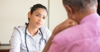 A clinician talks with patient