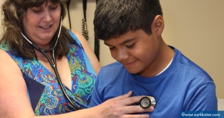 Migrant clinician gives patient a check up