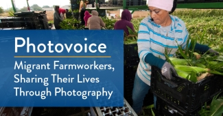 Farmworker moves a crate of corn