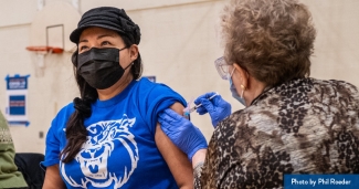 A woman receives the COVID-19 vaccine