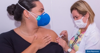 A woman receives the COVID-19 vaccine