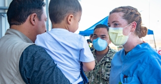 A nurse speaking with Afghan refugees