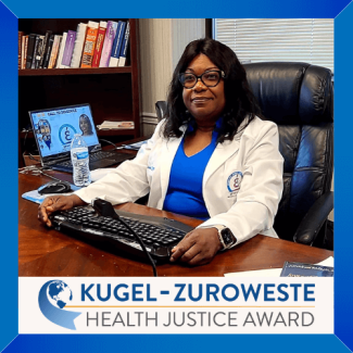 Emanie Dorival, 2022 winner of the Kugel-Zuroweste Health Justice Award, sits at the desk in her clinic.