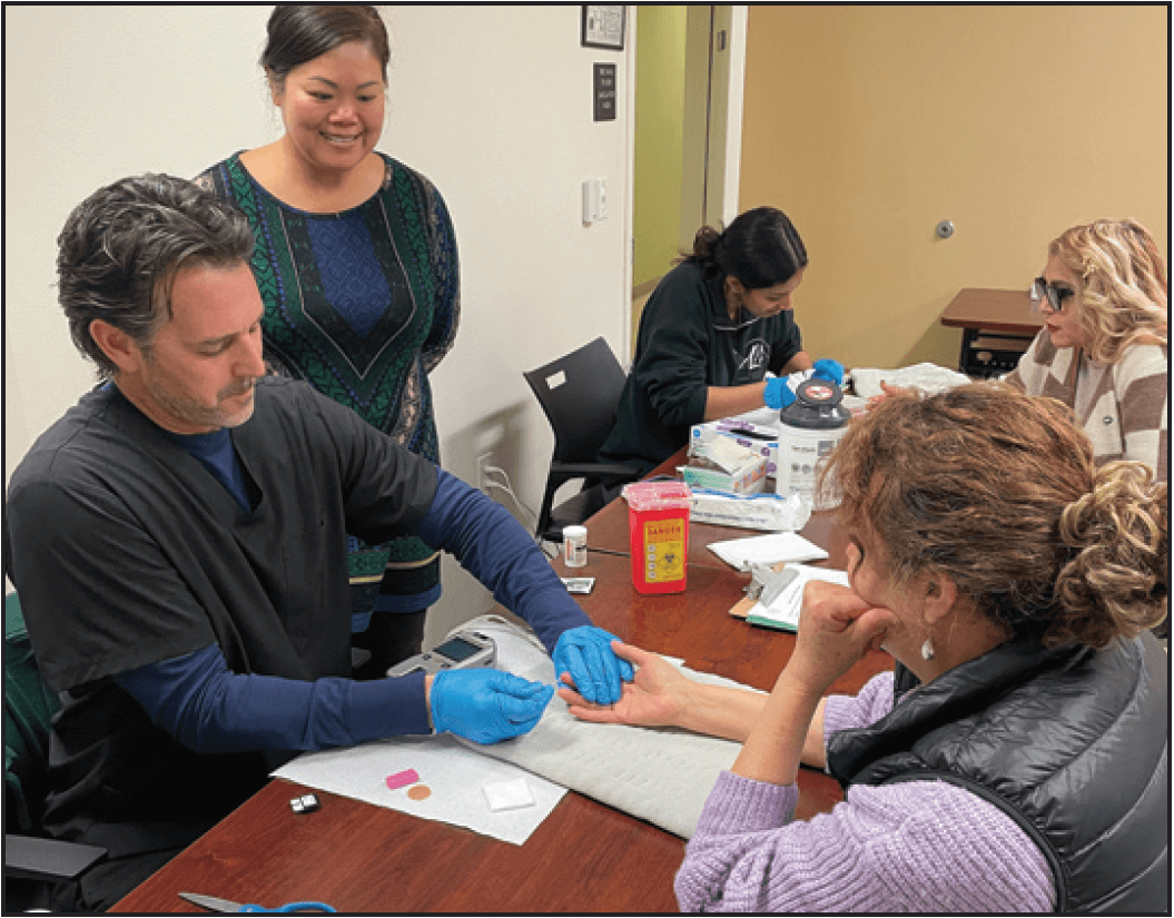 Salud en tu plato, a program highlighted in this issue, is run by Eat for the Earth, an example of a CBO that partnered with a local community health center to make positive health changes in the community. Here, volunteers from the CBO take vitals from participants at the health center.