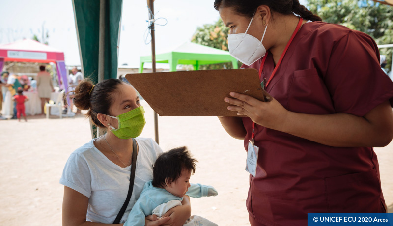 Nurse speaks with woman and child